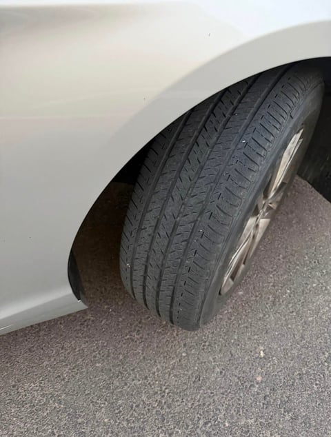 Close-up of a vehicle tire with tread pattern visible