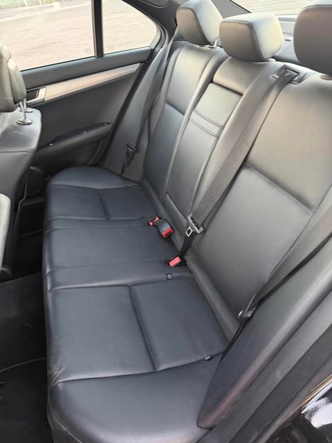 Interior view of car rear seats with gray leather upholstery
