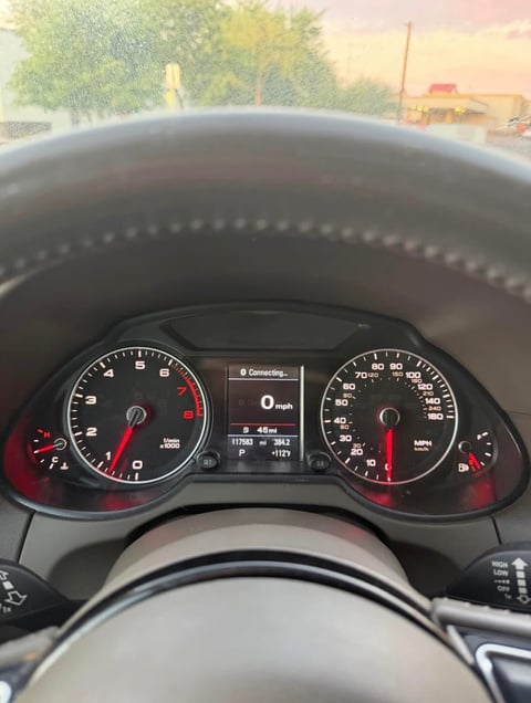 Close-up of Audi dashboard showing speedometer and tachometer