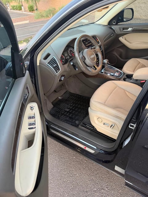 Audi interior with beige leather seats, steering wheel, and dashboard