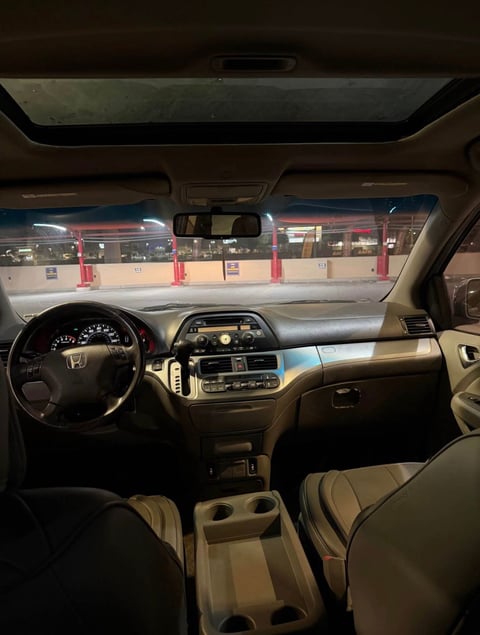 Interior view of a Honda van from driver seat showing steering wheel and dashboard